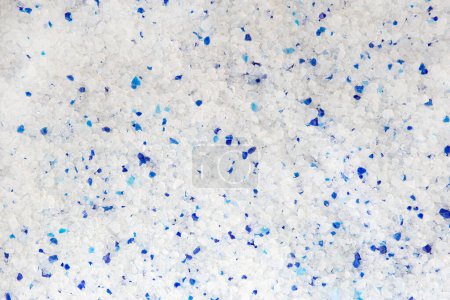 Silica gel white with blue crystals cat litter close-up. Abstract background of pure silica gel crystals.