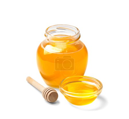 Photo for Organic honey in a glass jar and a transparent bowl, wooden dipper on a white background. Spoon for honey and fresh honey in an open jars on isolation close-up. Healthy products. - Royalty Free Image