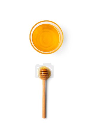 Photo for Creative composition, a wooden dipper lies in a drop of honey and a bowl with honey on a white background top view copy space - Royalty Free Image