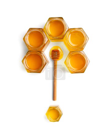 Photo for Creative composition of honey in open jars in the form of honeycombs and a wooden dipper on a white background top view. The concept of organic bee products. Honey on isolation. - Royalty Free Image