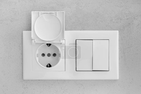 Téléchargez les photos : Closed socket and switch on porcelain stoneware in the bathroom - en image libre de droit