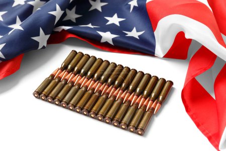 Foto de Bandera americana, balas, municiones, cartuchos para armas de fuego sobre fondo blanco. El concepto de préstamo-arrendamiento, apoyo, venta de armas. - Imagen libre de derechos