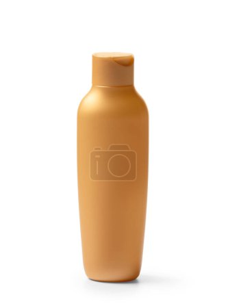 Foto de Botella de plástico de color dorado para gel, loción, crema, champú sobre fondo blanco. Embalaje, envase para productos cosméticos para el cuidado de la cara, el cuerpo y el cabello. - Imagen libre de derechos