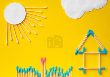 Photo for Composition of cotton swabs and discs on a yellow background. The concept of eco-friendly, natural, biodegradable materials, hygiene items, environmental protection, ecology problems. - Royalty Free Image
