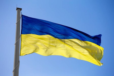 Foto de Flag of ukraine against the blue sky close-up. National pride and symbol of the country Ukraine. War in Ukraine. Yellow-blue flag. - Imagen libre de derechos