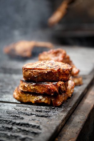 Photo for Appetizing, juicy ribeye steaks are grilled in a restaurant, close-up. Grilled meat. - Royalty Free Image