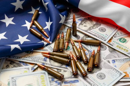 American flag, dollars, bullets, shells, cartridges, ammunition. The concept of lend-lease, army, arms sales. Military industry, war, world arms trade.