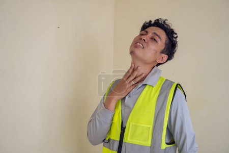 Photo for Young construction guys wear the wearpack with thirsty pose. The photo is suitable to use for engineer poster and safety content media. - Royalty Free Image