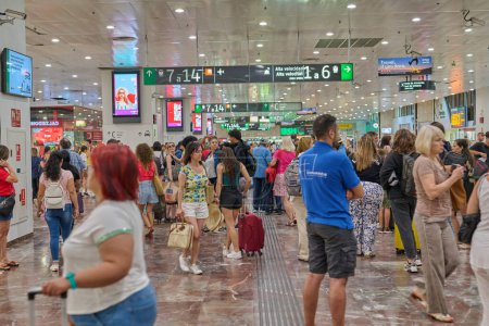 Photo for 04-08-2023. Barcelona, Spain, train arriving at the platform with people at Barcelona Sants station - Royalty Free Image