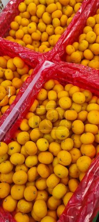 Photo for View of pile of oranges being sold in market place, top view of sunkist oranges, yellow round fruits, fresh fruit background - Royalty Free Image