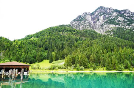 Photo for Heiterwanger See in Austria. View of the blue-green lake and the surrounding mountains. Landscape near Heiterwang. - Royalty Free Image
