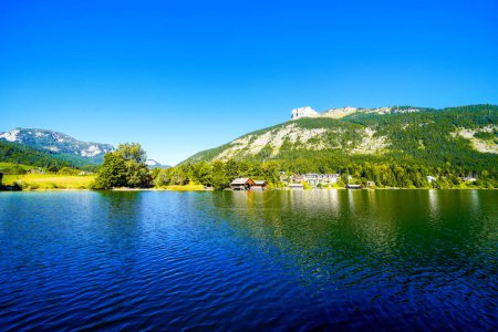 Landscape at Lake Altaussee in the Salzkammergut in Austria. Idyllic nature by the lake in Styria. Altaussee at Totes Gebirge with a view of the surrounding mountains.