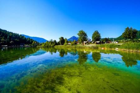 Photo for Landscape at Lake Altaussee in the Salzkammergut in Austria. Idyllic nature by the lake in Styria. Altaussee at Totes Gebirge with a view of the surrounding mountains. - Royalty Free Image