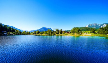 Photo for Landscape at Lake Altaussee in the Salzkammergut in Austria. Idyllic nature by the lake in Styria. Altaussee at Totes Gebirge with a view of the surrounding mountains. - Royalty Free Image