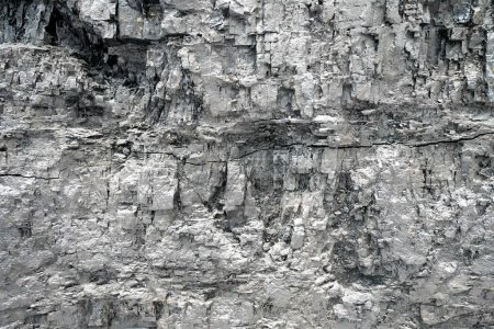 Gray wall made of coal. Coal mining area in a mine. Texture as a gray background.