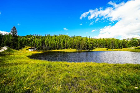 Photo for Krallersee on the high plateau of the Tauplitzalm. View of the lake at the Toten Gebirge in Styria. Idyllic landscape with green nature and a lake on the Tauplitz. - Royalty Free Image