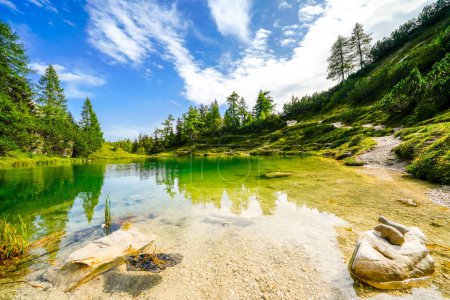 Photo for Fairy tale lake on the high plateau of the Tauplitzalm. View of the lake at the Totes Gebirge in Styria. Idyllic landscape with mountains and a lake on the Tauplitz. - Royalty Free Image