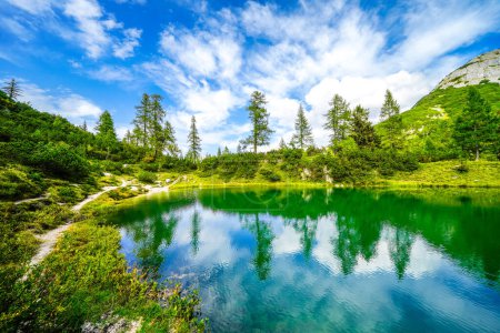 Photo for Fairy tale lake on the high plateau of the Tauplitzalm. View of the lake at the Totes Gebirge in Styria. Idyllic landscape with mountains and a lake on the Tauplitz. - Royalty Free Image