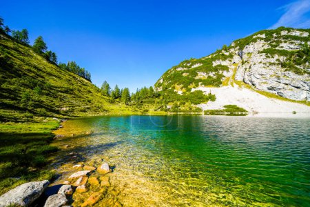 Photo for Schwarzensee on the high plateau of the Tauplitzalm. View of the lake at the Totes Gebirge in Styria. Idyllic landscape with mountains and a lake on the Tauplitz in Austria. - Royalty Free Image