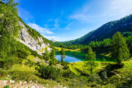 Photo for Schwarzensee on the high plateau of the Tauplitzalm. View of the lake at the Totes Gebirge in Styria. Idyllic landscape with mountains and a lake on the Tauplitz in Austria. - Royalty Free Image