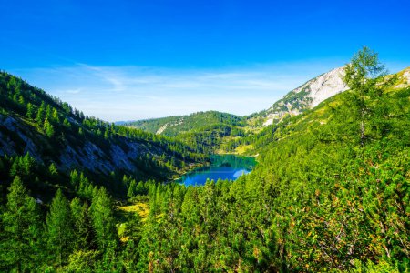 Photo for Steirersee on the high plateau of the Tauplitzalm. View of the lake at the Toten Gebirge in Styria. Idyllic landscape with mountains and a lake on the Tauplitz in Austria. - Royalty Free Image