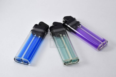 Foto de Multicolored plastic gas lighter. Gas lighter isolated on white background. Closeup shot - Imagen libre de derechos
