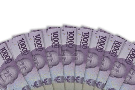 Foto de Indonesian rupiah banknotes series with the value of 10000 rupiah. IDR 10.000 issue 2016, Indonesian rupiah for background. Top view, Copy space - Imagen libre de derechos