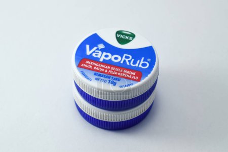 Photo for Pasuruan, 03 Desember 2022 - Closeup on bottle of vicks vaporub. It is a medicinal balm for treating small respiratory diseases. Vicks VapoRub ointment is a mentholated topical cream - Royalty Free Image