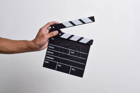 man's hand holding a Clapper board isolated on white background