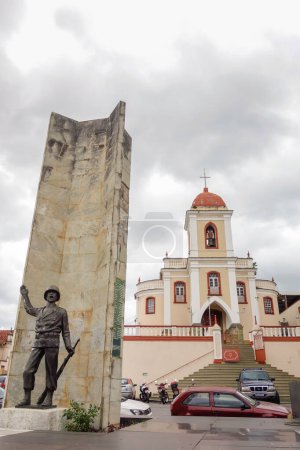 Photo for Sao Joao del Rei, MG, Brazil - 01.03.23: heroe statue and church of colonial city. - Royalty Free Image