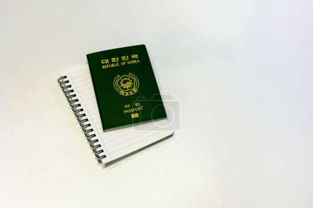 Téléchargez les photos : Republic of Korea passport with notebook on the white background - en image libre de droit