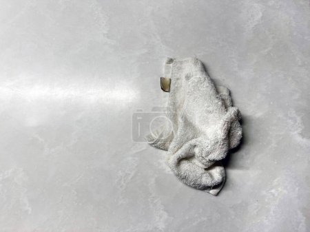 Photo for Dirty dishcloth on the marble table - Royalty Free Image
