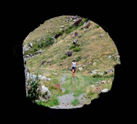 Foto de Silhouette of a hiker girl in a natural grotto. High quality photo - Imagen libre de derechos