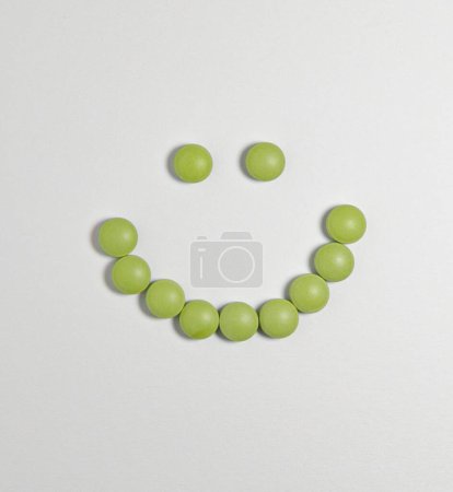 Photo for Smiley face made of green pills - Royalty Free Image