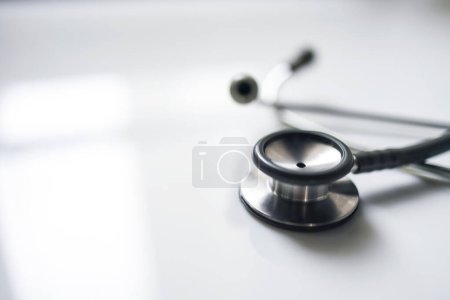 Photo for Medical stethoscope on white blur background with copy space inside hospital.Close up photo of tool for doctor or veterinary use.Beautiful clipboard for text.Clean ear piece and tube. - Royalty Free Image