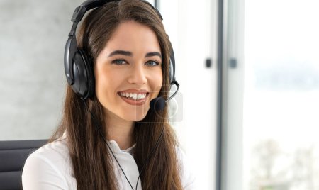 Photo for Close up portrait of smiling female customer service consultant with headset talking with client during phone call - Royalty Free Image