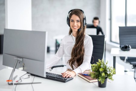 Photo for Portrait of beautiful young woman in headset working as telephone worker in call center - Royalty Free Image