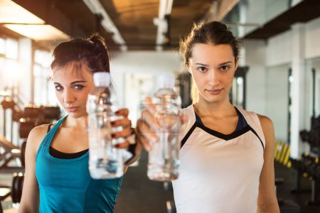 Photo for Young fitness women with water bottles. - Royalty Free Image