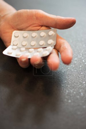 Photo for Close up of senior womans hand with pills. - Royalty Free Image