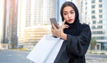 Photo for Muslim woman using mobile phone - Royalty Free Image