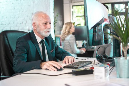 Photo for Senior business man wearing formalwear working on computer in office - Royalty Free Image