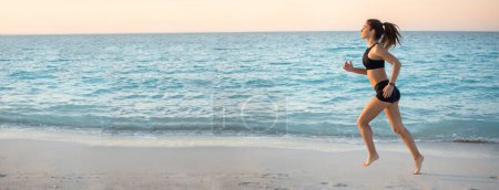 Photo for Fit young sporty girl running on the beach. Panoramic view - Royalty Free Image