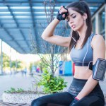 Young fit woman resting after workout outdoors