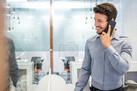 Foto de Empresario hablando por teléfono en la oficina - Imagen libre de derechos