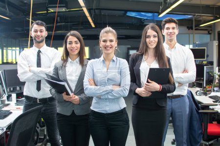 Photo for Group of young business people standing together in office - Royalty Free Image