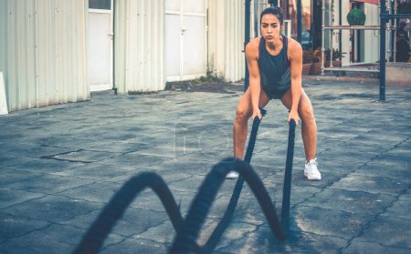 Photo for Fitness woman training with battle ropes outdoors - Royalty Free Image