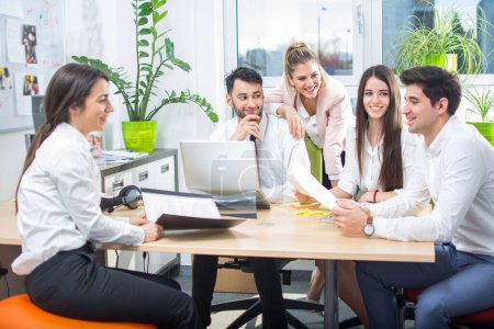 Photo for Entrepreneurs and business people conference in modern meeting room. Smiling business team talking while sitting around a conference table. - Royalty Free Image