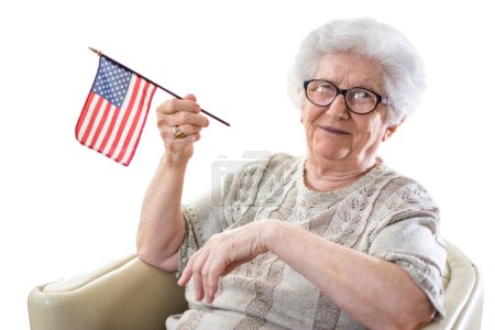 Photo for Senior woman holding American flag, isolated on white background. - Royalty Free Image