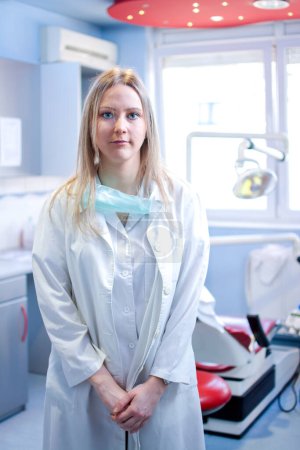 Photo for Portrait of young female dentist standing in dental office - Royalty Free Image