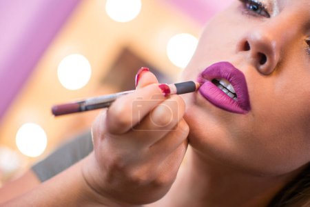 Photo for Beautiful woman applying lip liner to lips. Close up. - Royalty Free Image